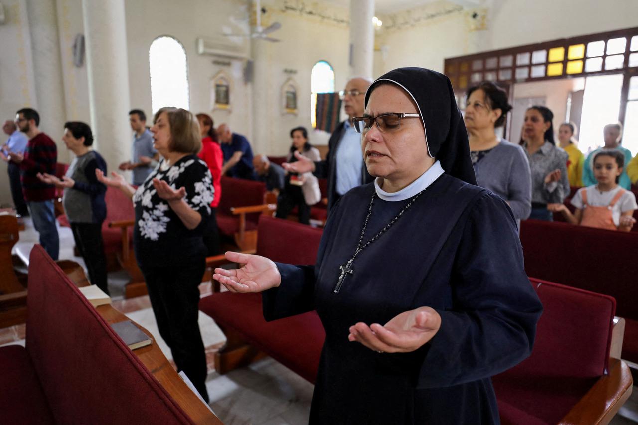 Palestinian Christians hold an Easter mass at the Holy Family Church, in Gaza City